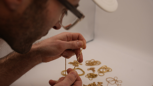 Expert appraising donated gold jewelry