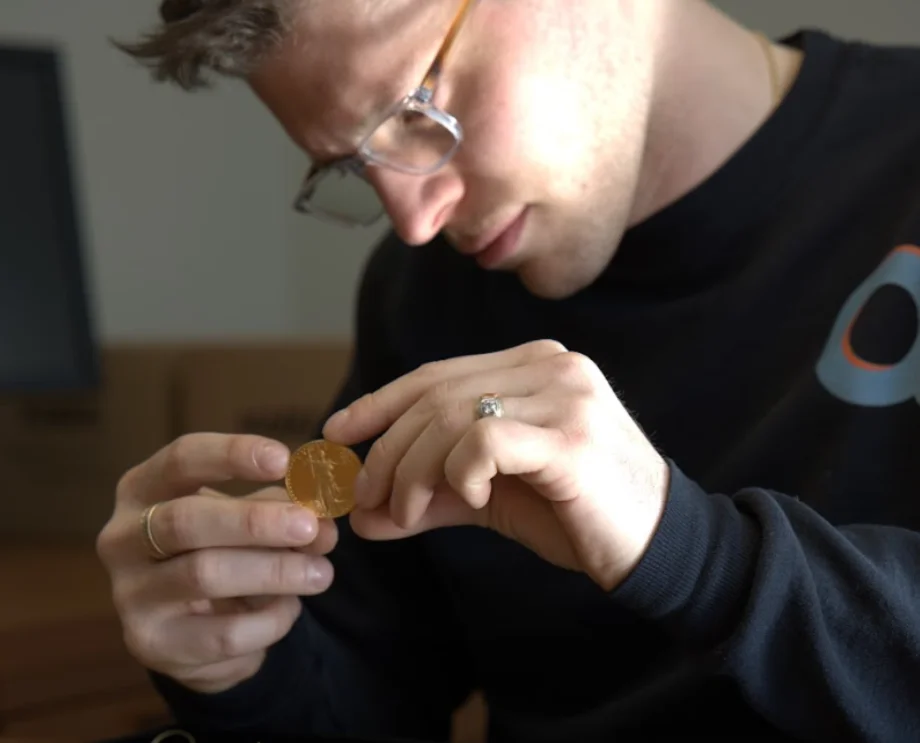 Inspecting gold coin for sale
