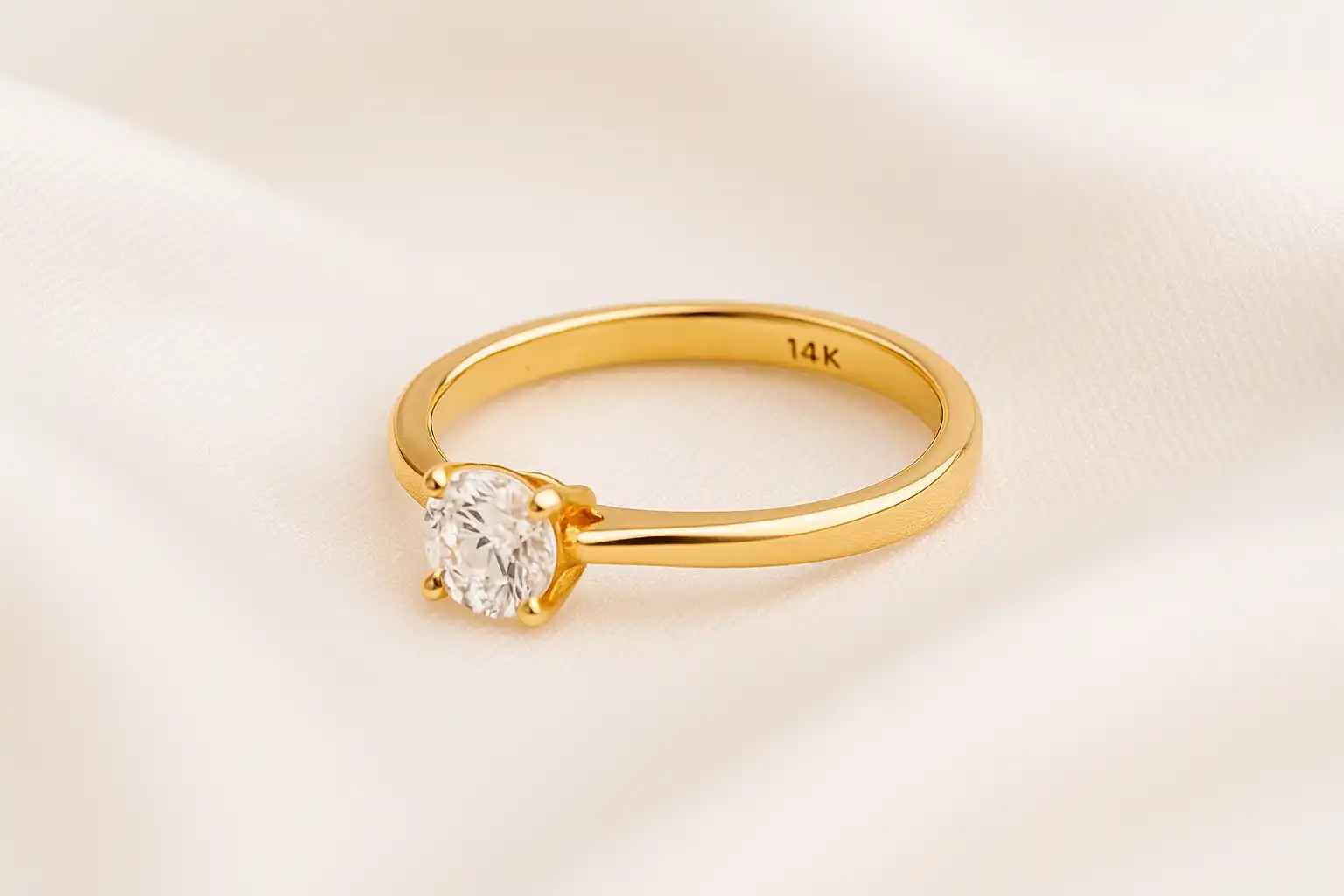 A gold diamond solitaire, stamped with 14K
