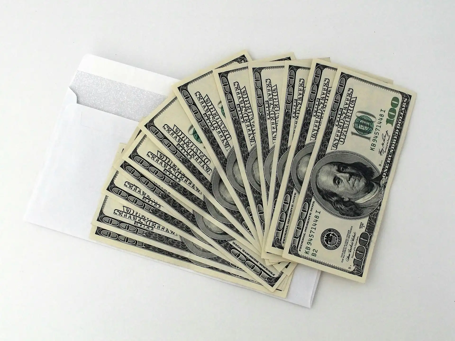 Money fanned out on a white table