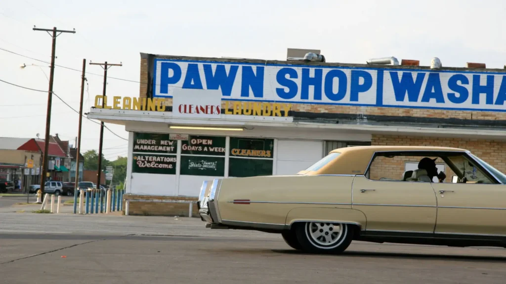 A car drives in front of a pawn shop