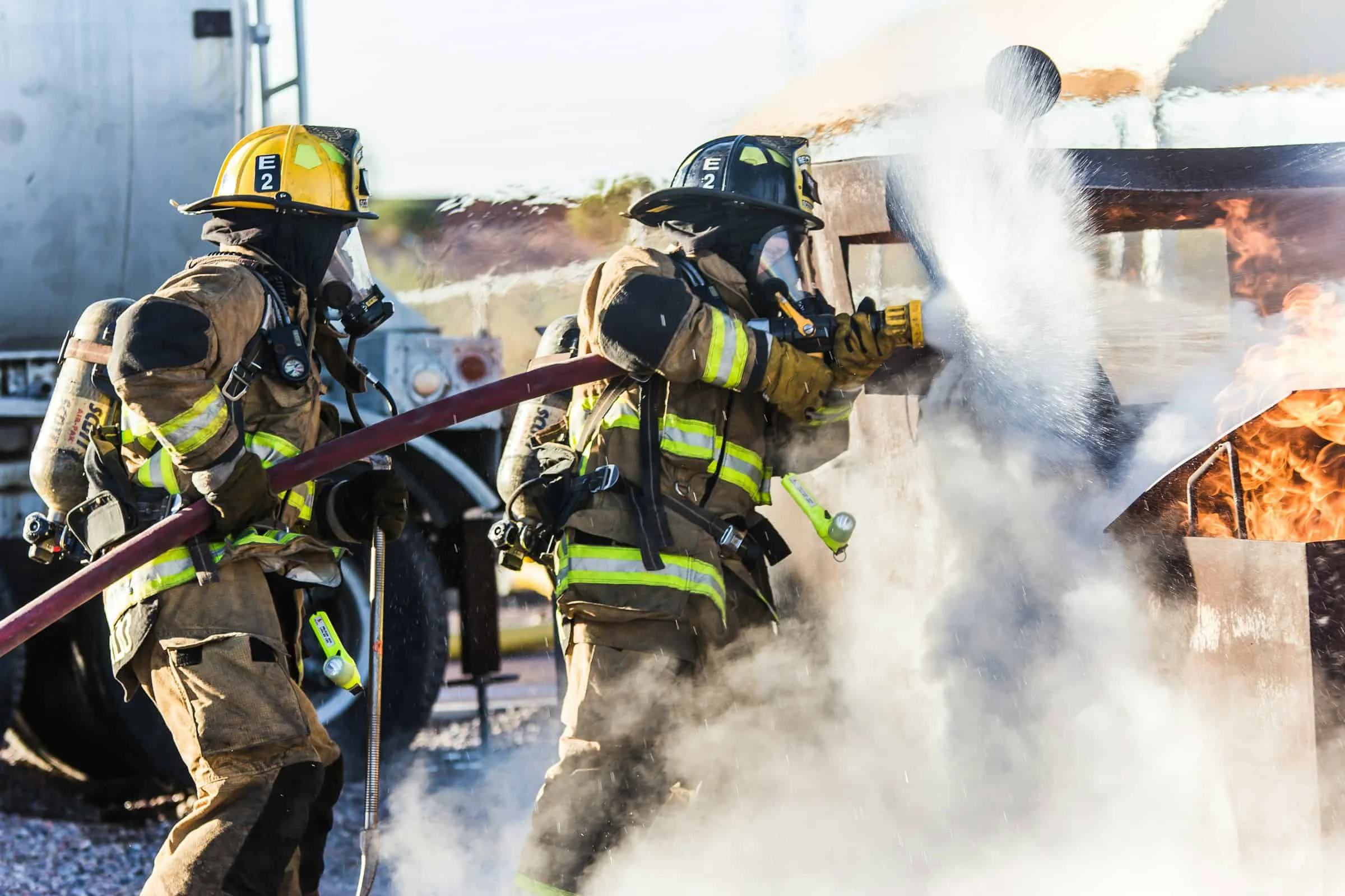 Fire fighters work together to put out flames.