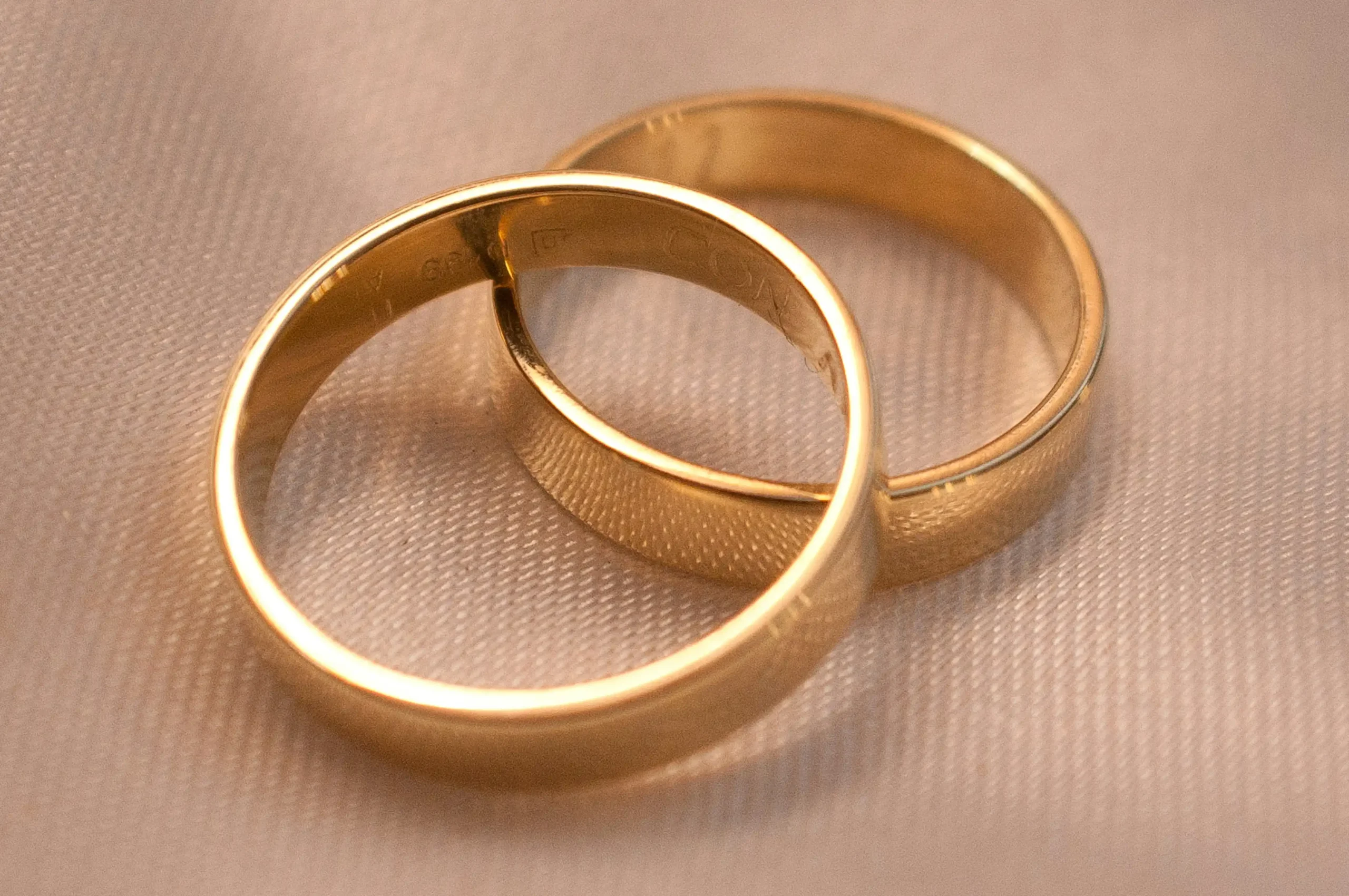 Two gold bands rest upon one another