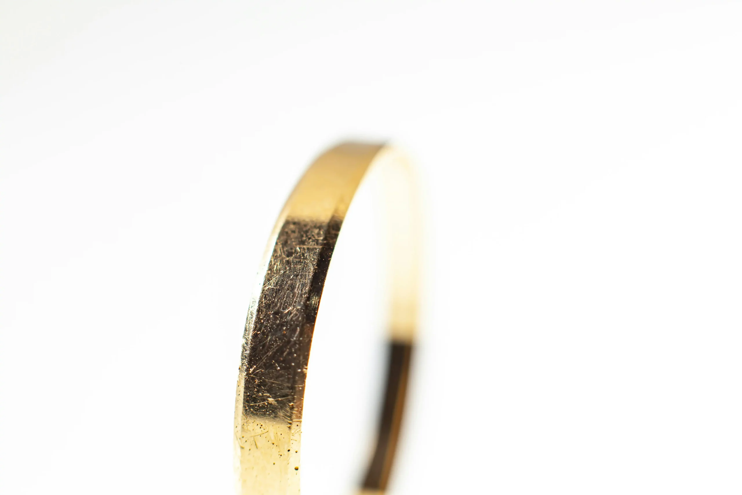 A gold band shows slight scratching on the surface