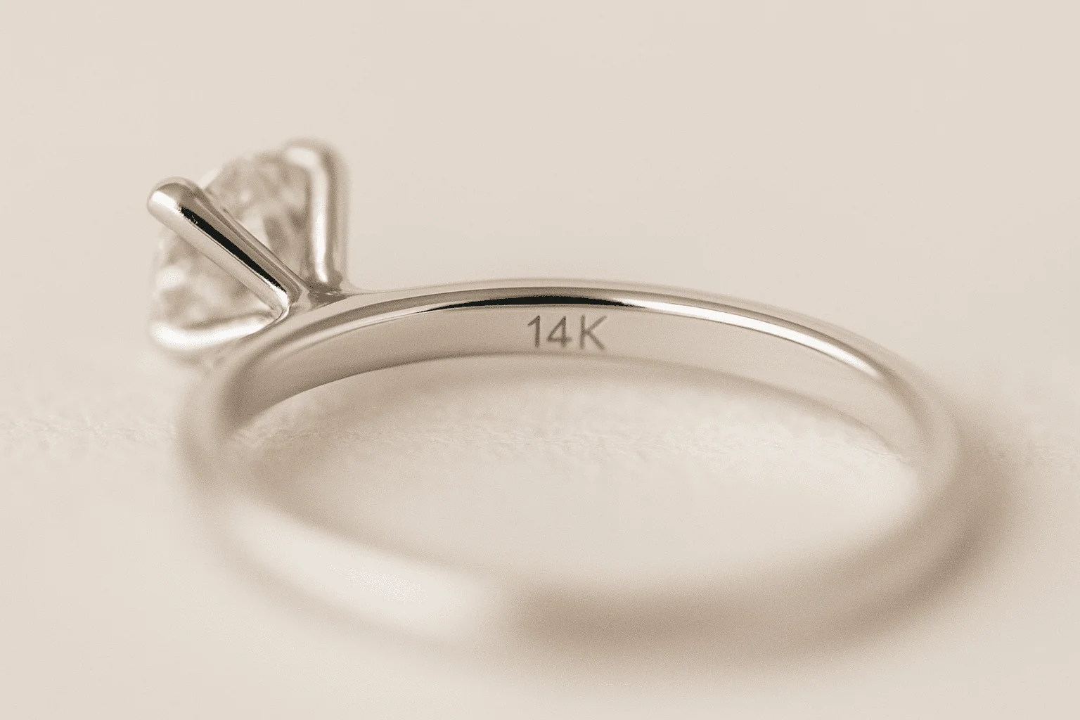 a white gold diamond solitaire features a 14K stamp