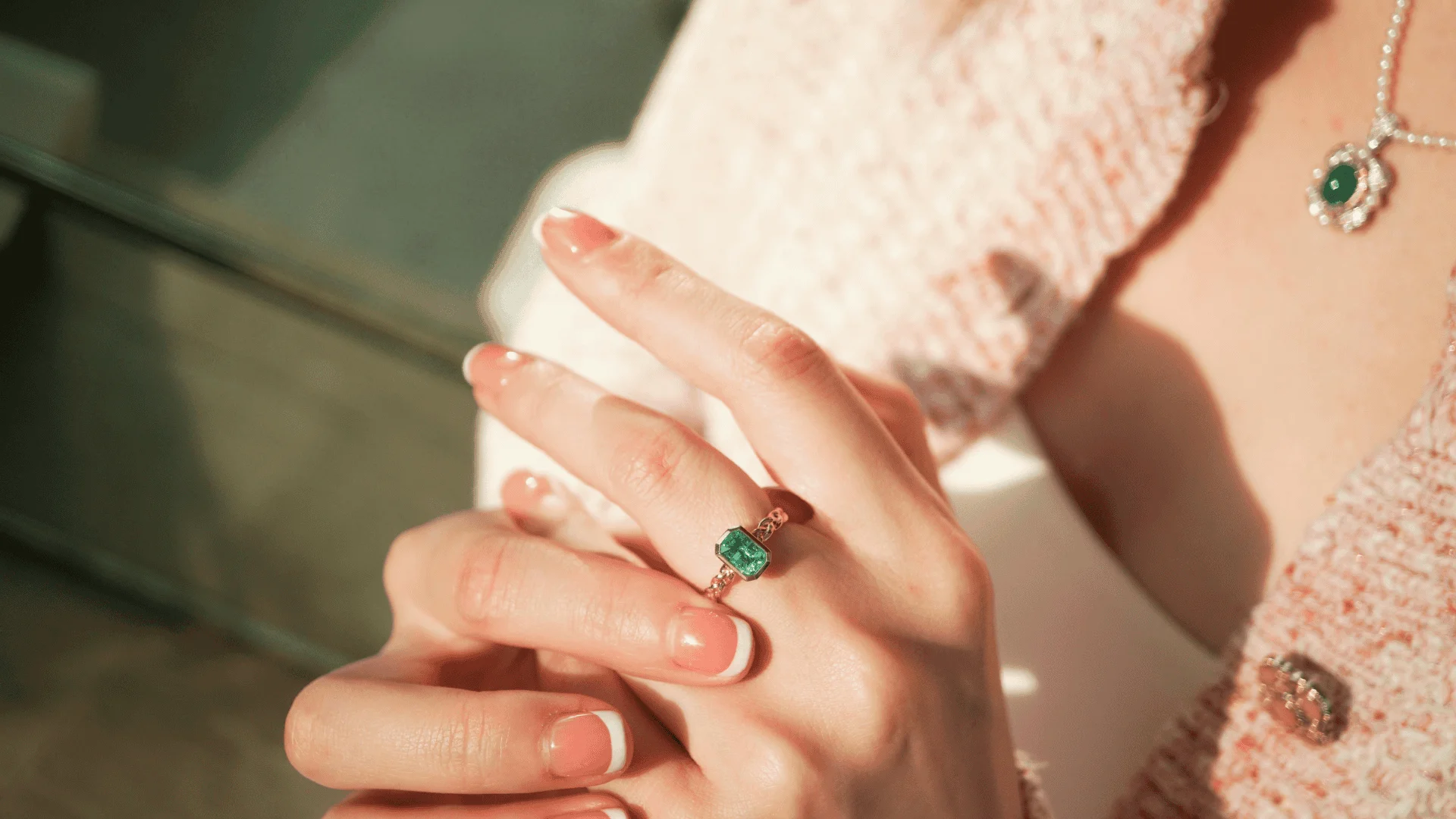 a woman wears a emerald ring
