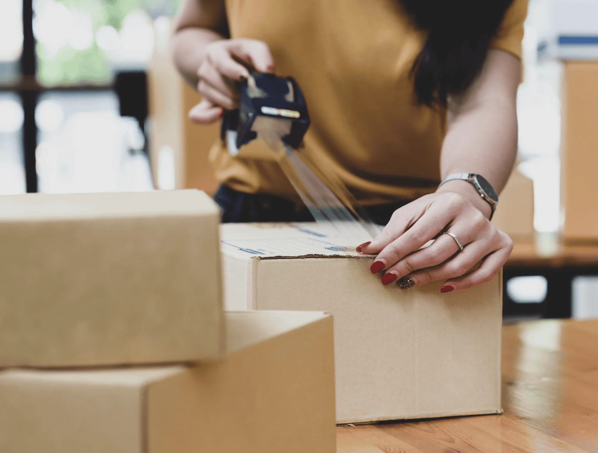 A woman packs a box for shipment