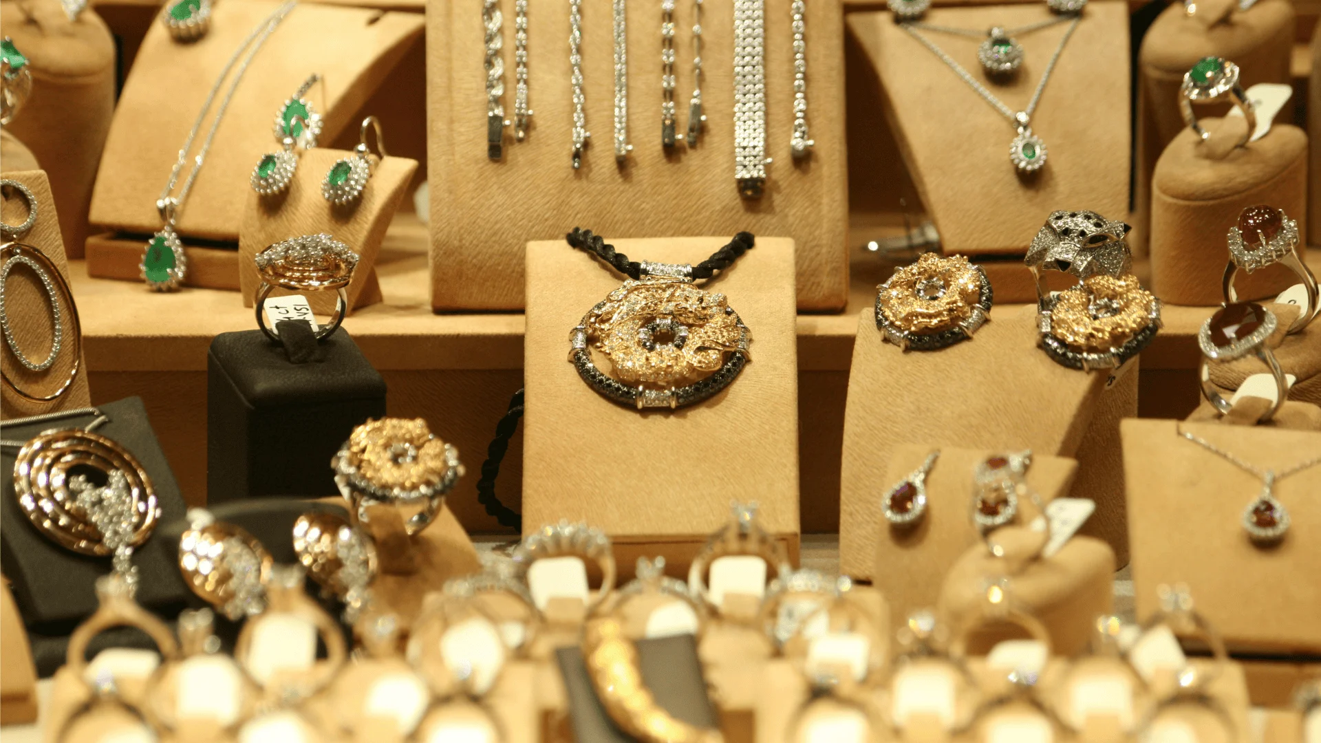 A jewelry store's glass case featuring various gold pieces