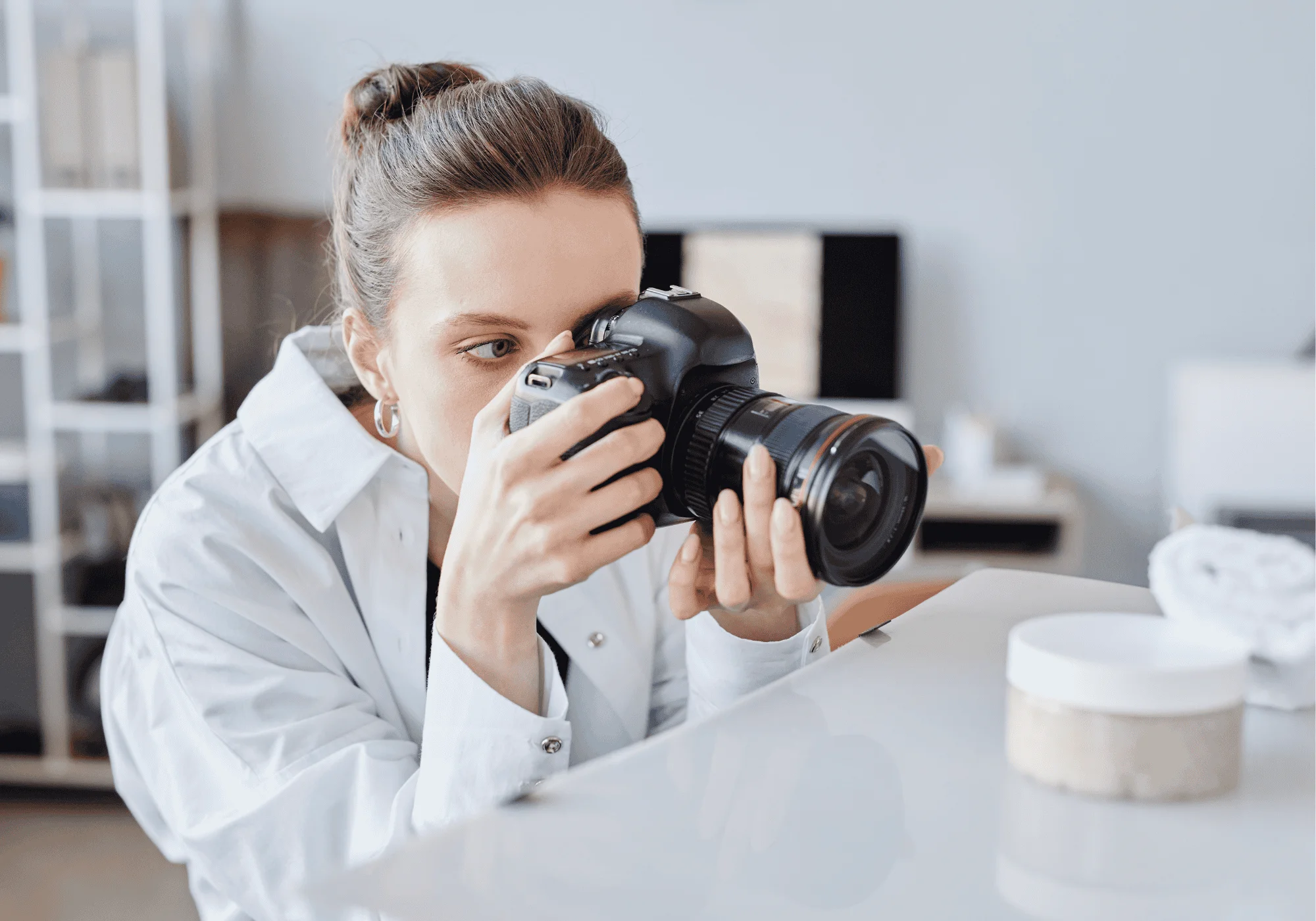 a woman with a DSLR takes product photos