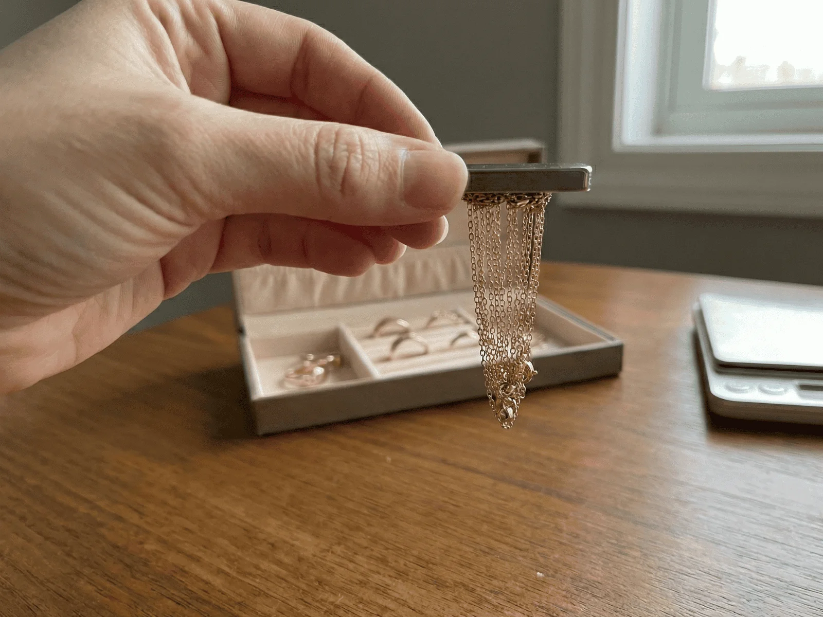 a person performs a magnet test on a necklace