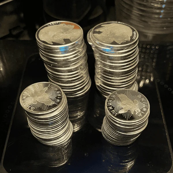 40 1 oz Silver Coins and 40 1/2 oz Silver Coins on a scale